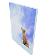 A red fox sits peacefully watching the snow fall limited edition print on canvas